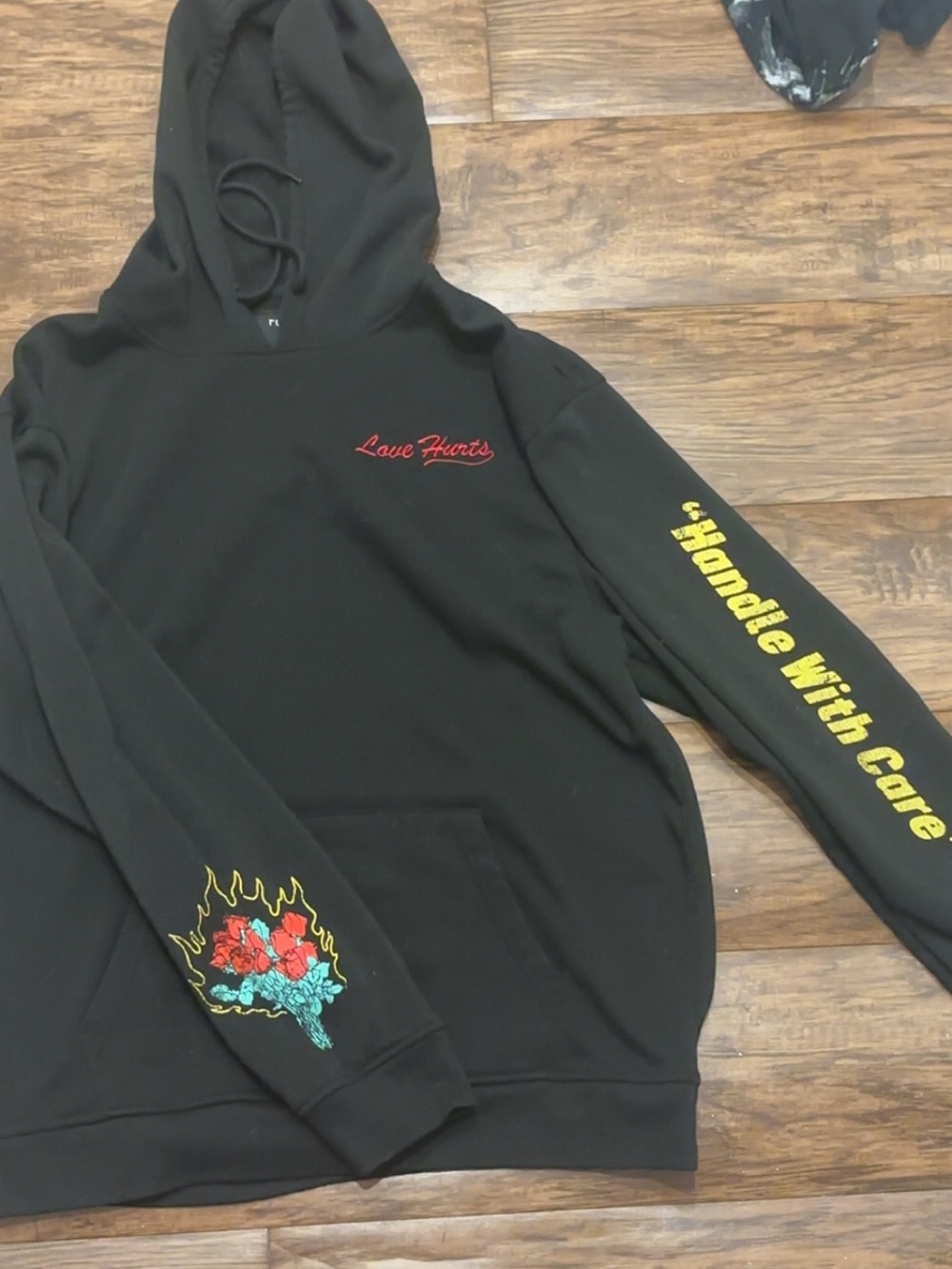 Rue21 Black 'Love Hurts' Hoodie with Yellow Sleeve Text and Floral Graphic